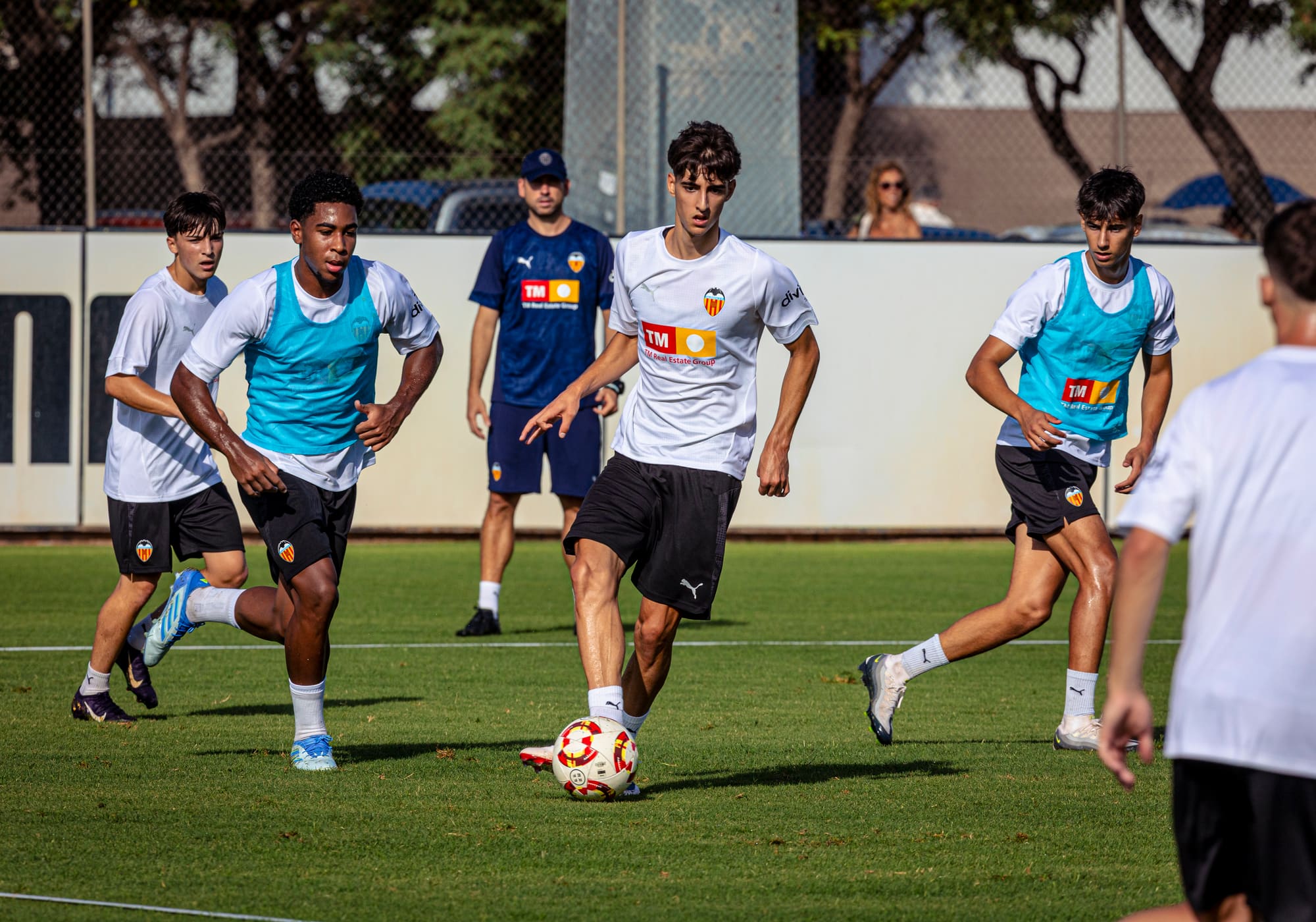 A player training beneath the Valencia CF crest at the academy in Paterna
